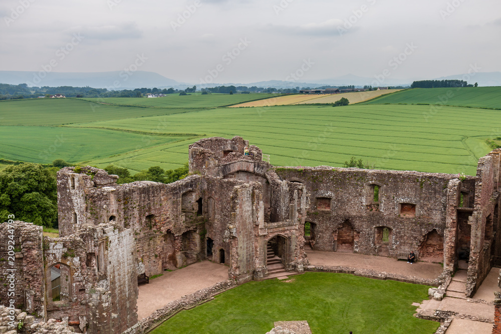 View from the ruins of an ancient medieval castle showing cultivated fields and farmland (Raglan Castle)