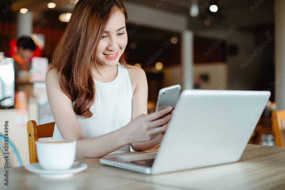 Beautiful Asia woman using laptop at cafe Beautiful Asia woman using laptop at cafe