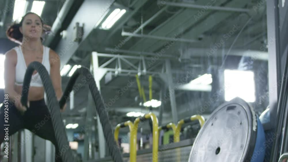 Attractive female athlete working out in a gym Attractive female athlete working out in a gym