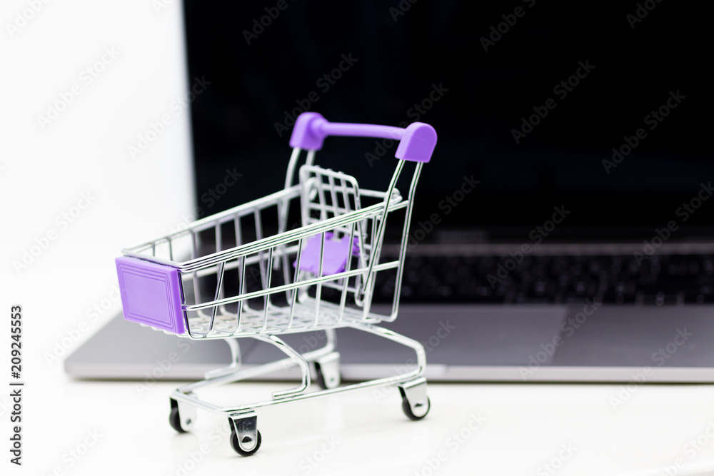 Shopping cart for retail business on notebook. Image use for online and offline shopping, marketing place world wide.