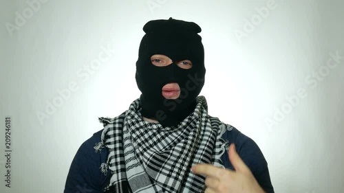 male terrorist speaking at the camera