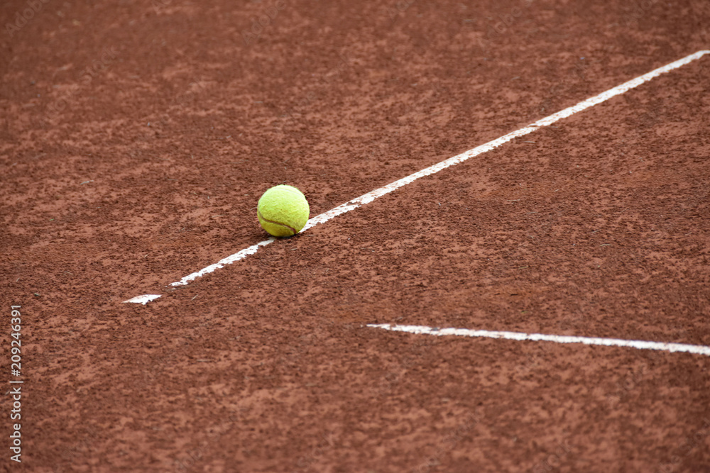 Ball on the line on tennis clay court