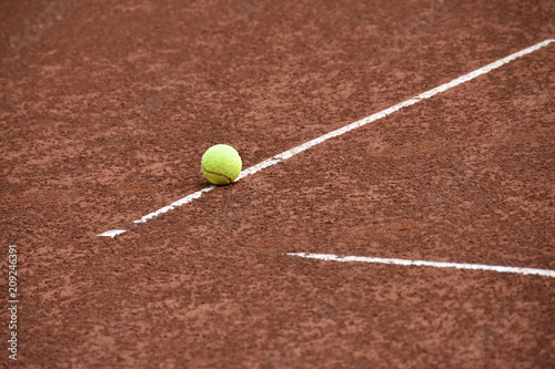 Ball on the line on tennis clay court © snowyns