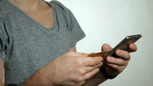 man is spending money with a credit card and smartphone