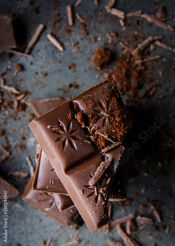 Pieces of chocolate and cacao’s dust. photo