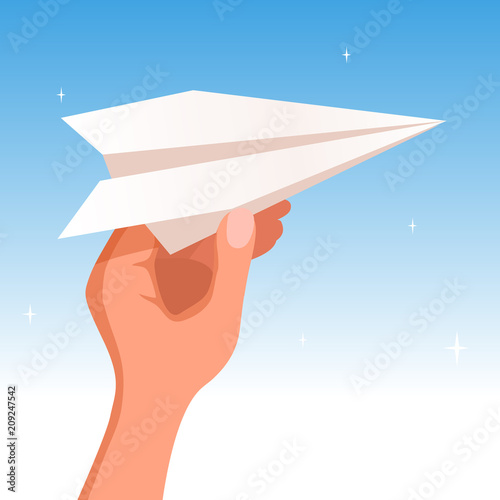 Hand holding a paper plane on the blue sky background