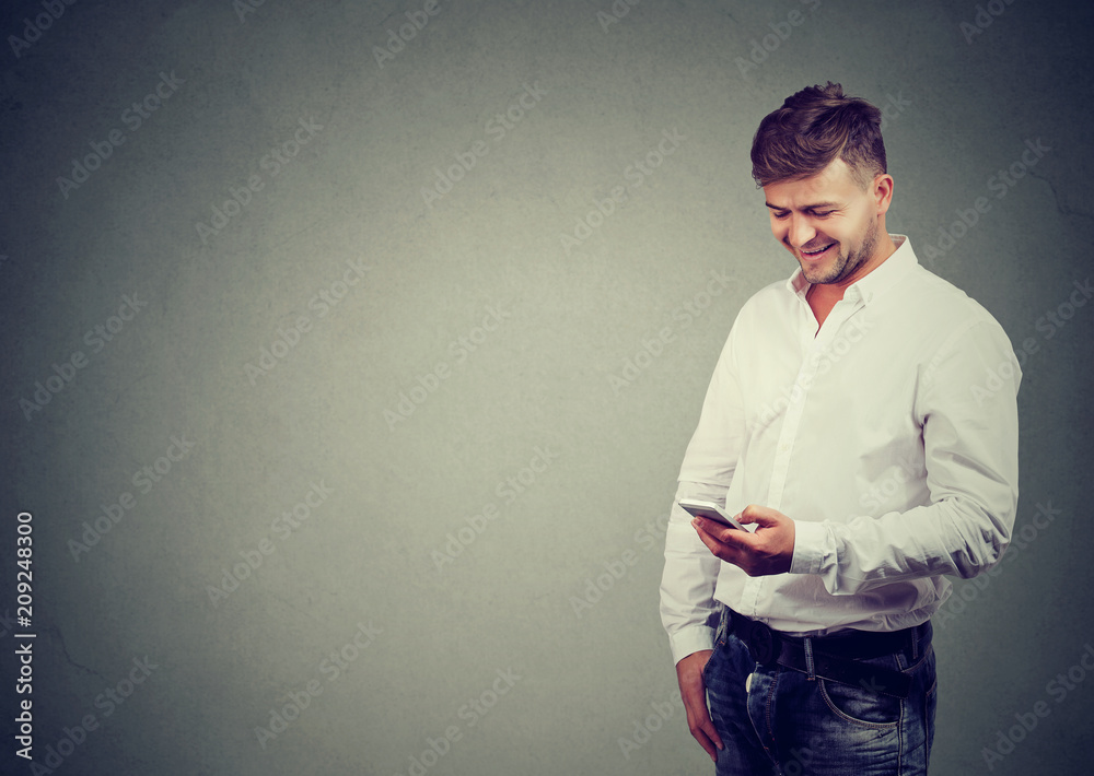 Casual man using phone with smile