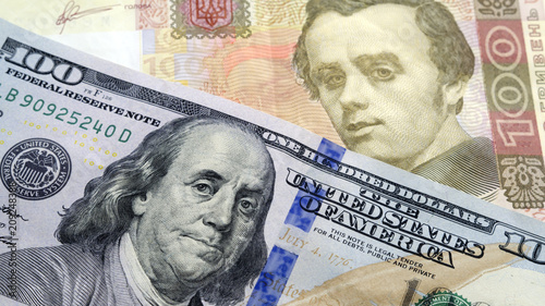 Wallpaper Mural Ukrainian cash hryvnia and dollars USA. Currency exchange rate concept. Dolar is located near the hryvnia at an angle to each other Torontodigital.ca