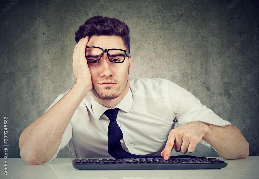 © Feodora - bored man employee sitting at desk has no motivation to work