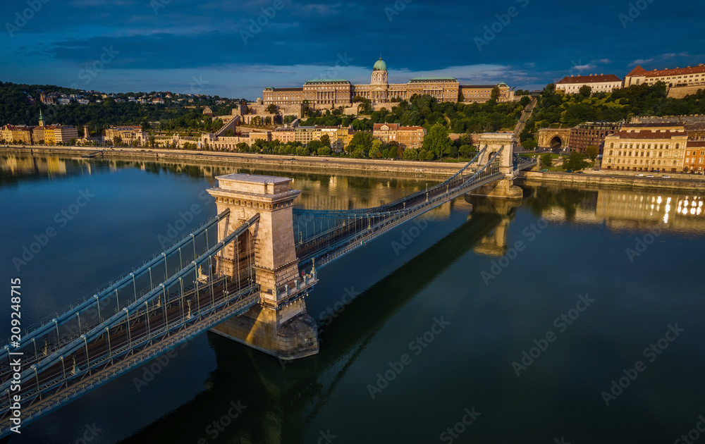 Budapest, Hungary - Aerial panoramic view of Szechenyi Chain Bridge with Buda Castle Royal Palace at background at sunrise