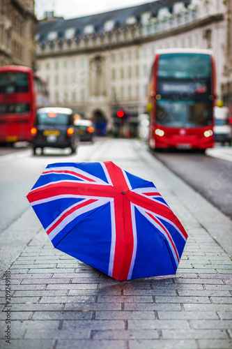 Photography London, England - British umbrella at busy Regent Street with iconic red double-