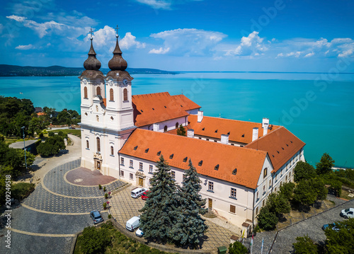 Tihany, Hungary - Aerial view of the famous Benedictine Monastery of Tihany (Tihany Abbey) with beautiful coloruful Lake Balaton and blue sky at background photo