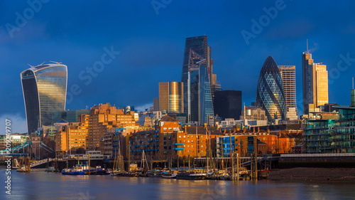 London  England - Beautiful dramatic sky and golden hour sunlight at Bank District of London with famous skyscrapers