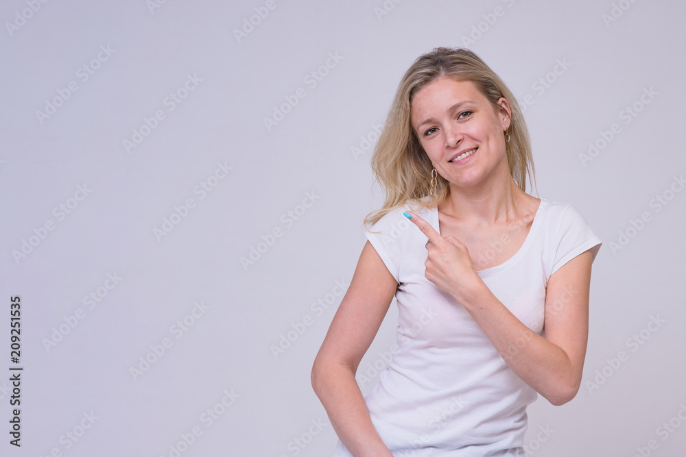 portrait of a beautiful blond girl on a white background shows on a product portrait of a beautiful blond girl on a white background shows on a product