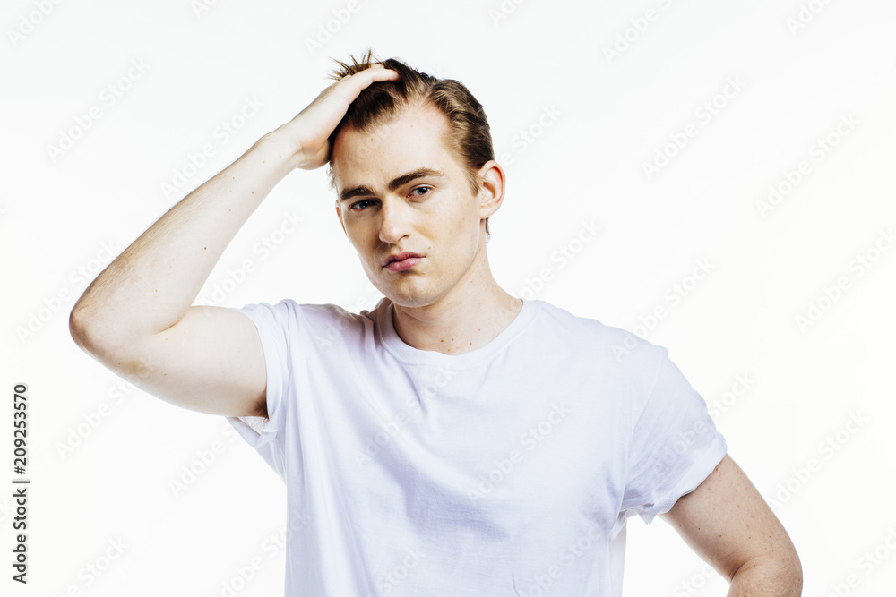 Portrait of a young expressive man on white studio background