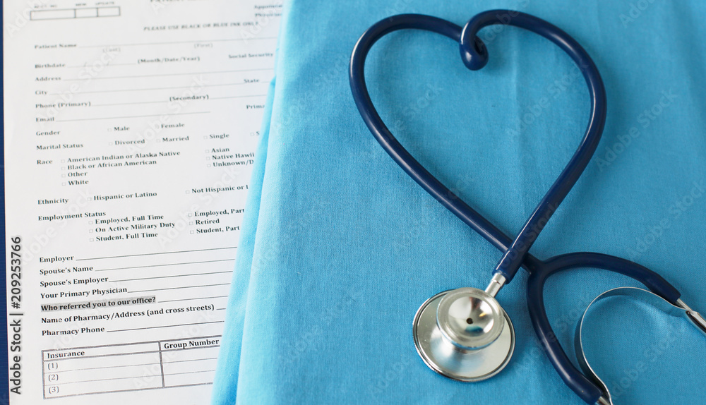 A stethoscope shaping a heart on a medical uniform, closeup, selective focus A stethoscope shaping a heart on a medical uniform, closeup, selective focus