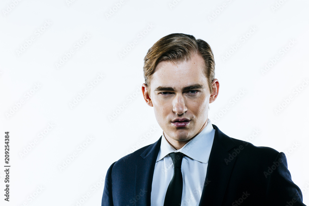 Portrait of a young man in suit and tie on white studio background Portrait of a young man in suit and tie on white studio background