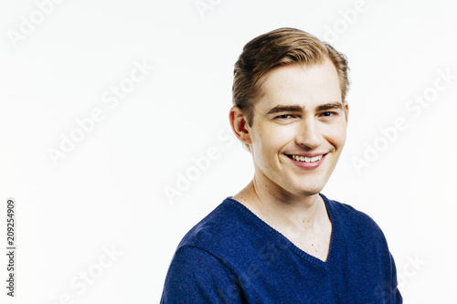 Portrait of a young expressive man with big smile on white studio background