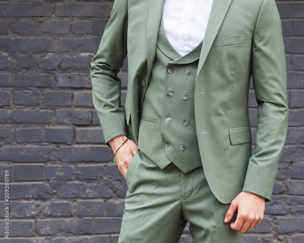 custom made wallpaper toronto digitalFashion man. Young businessman with a beard in a fashionable green suit posing against a black brick wall