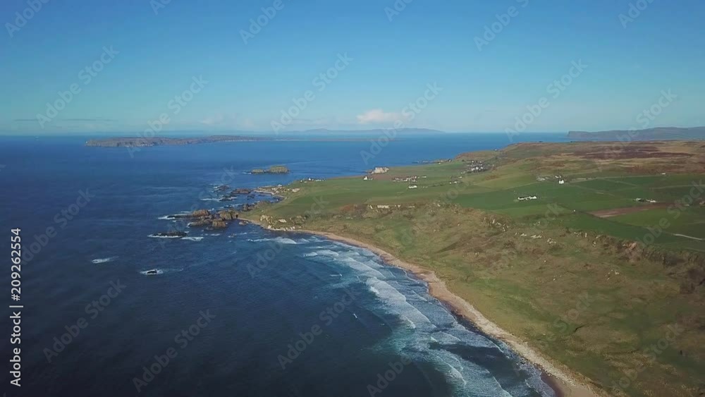 4k Aerial Shot of ocean waves and beautiful beach in Northern Ireland