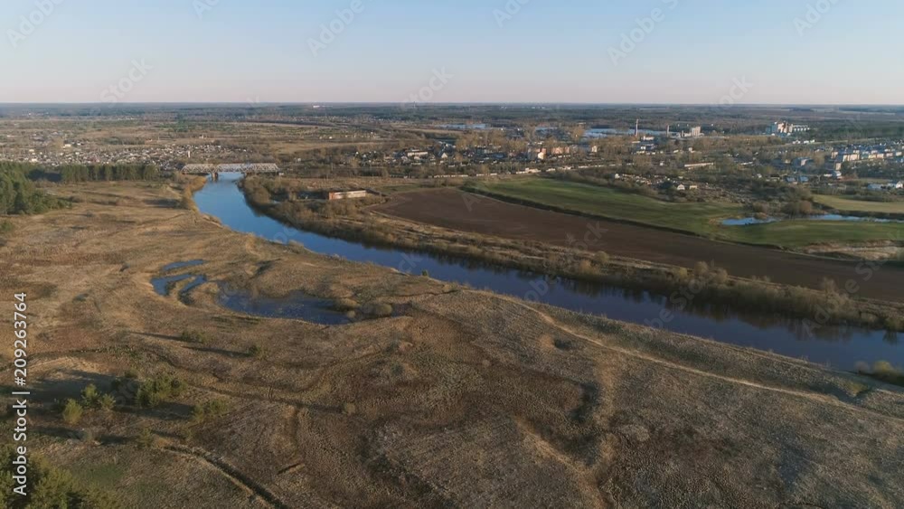 Flight above green fields, forest, river and village early spring, aerial panoramic view. Flight above green fields, forest, river and village early spring, aerial panoramic view.