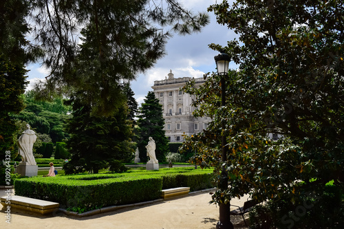 The Royal Palace of Madrid seen through several of its trees. Photograph taken in the gardens of Sabatini in Madrid at the Royal Palace (Spain) © kino1493
