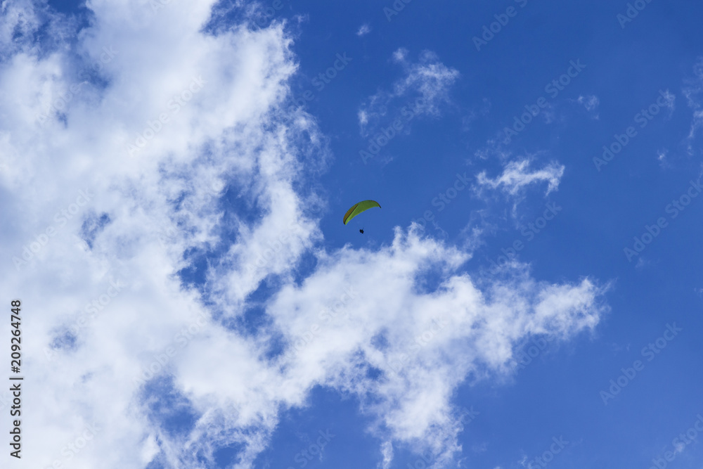 Skydiver against the blue sky and white clouds Skydiver against the blue sky and white clouds