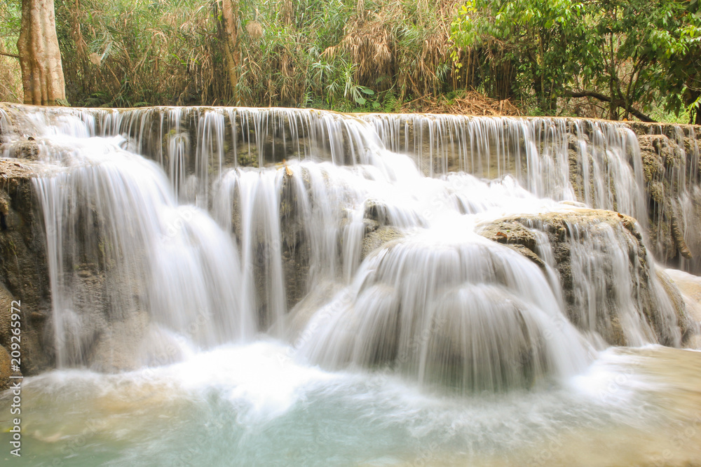 Kuang Si Falls nearby Luang Prabang, Laos. Wild forest, nature landscape. Long exposure shot waterfalls