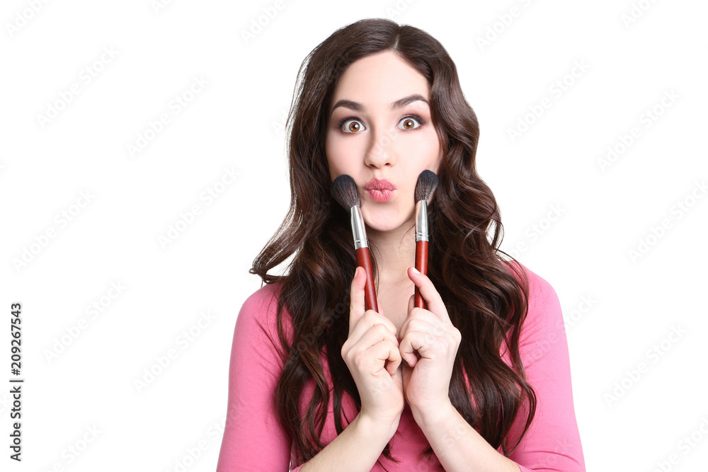 Beautiful woman with makeup brushes on white background Beautiful woman with makeup brushes on white background