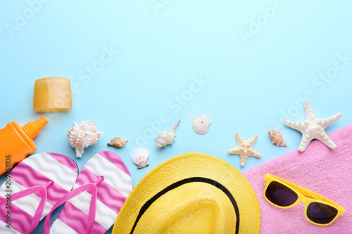 Beach accessories with seashells on blue background