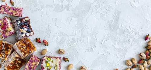 Turkish delight, pistachio and small dry roses. photo