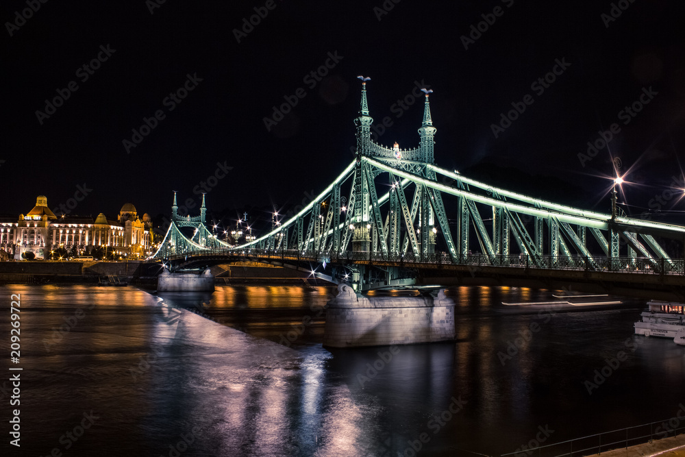 night bridge urban colorful cityscape with reflection on river and dark sky