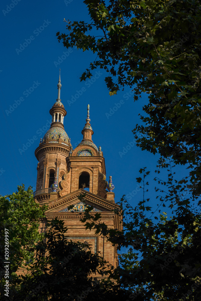 Spain, Seville, LOW ANGLE VIEW OF TREES AND BUILDING AGAINST SKY AT NIGHT in Plaza de Espana