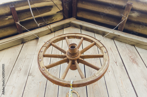 Wheel of a cart hanging as a decoration over the barn entrance.
