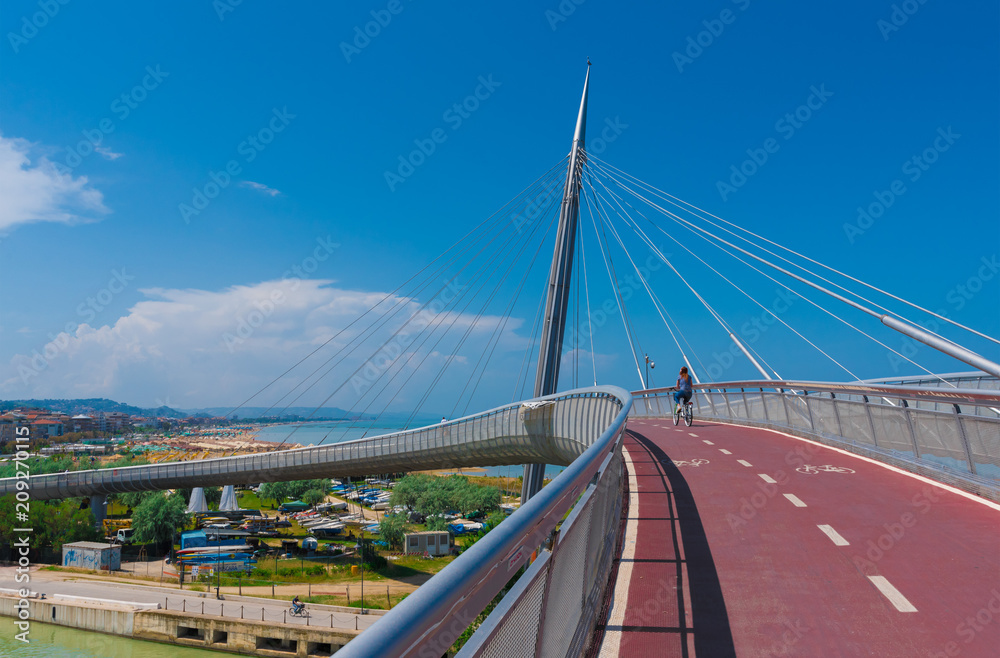 Fototapeta premium Pescara, Italy - 31 May 2018 - The Ponte del Mare monumental bridge and the Ferris wheel on the beach, in the canal and port of Pescara city, Abruzzo region