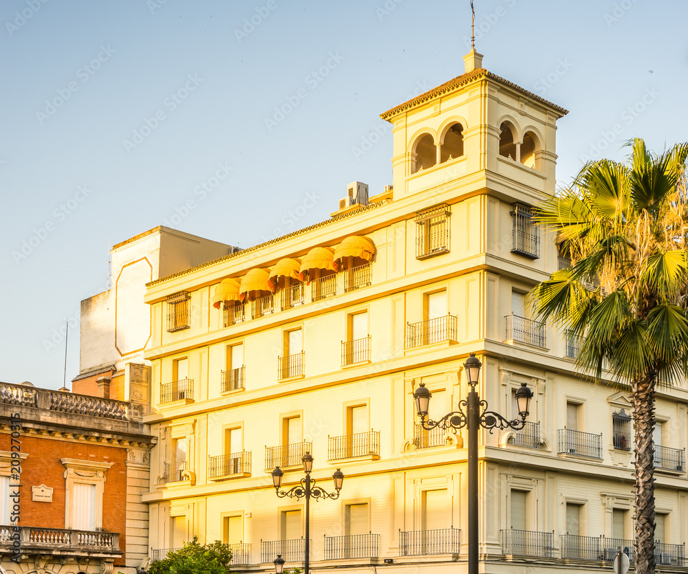 Fototapeta premium Spain, Seville, BUILDINGS BY STREET IN CITY AGAINST CLEAR SKY