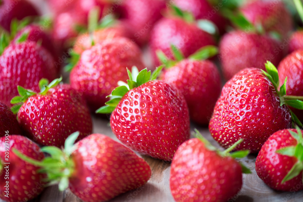 Red strawberry on a wooden table. Farm fruits and berries. Red strawberry on a wooden table. Farm fruits and berries.
