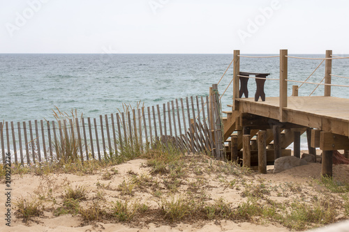 wooden bridge through sand dunes