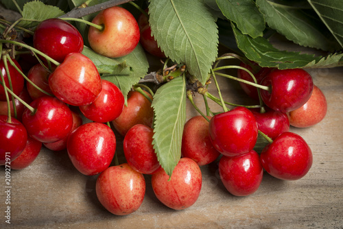 Fresh cherries on a wooden table background