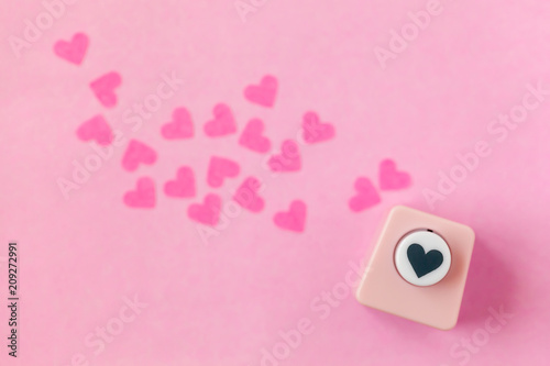 Decoration for Valentine's Day: hole puncher made paper shapes of pink hearts