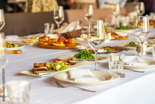 A decorated banquet table with appetizers awaiting guests