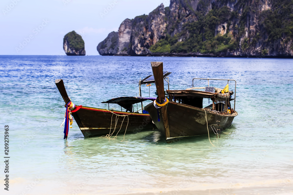 Long tail boat on Phi Phi Islands, Thailand.An exotic place. Long tail boat on Phi Phi Islands, Thailand.An exotic place.