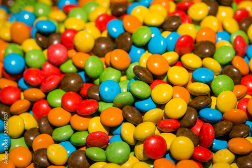 Delicious multicolored sweets, sweet and sour. Chocolate, lollipop, gum. Useful and harmful sweets, which are loved by both children and adults. Background.