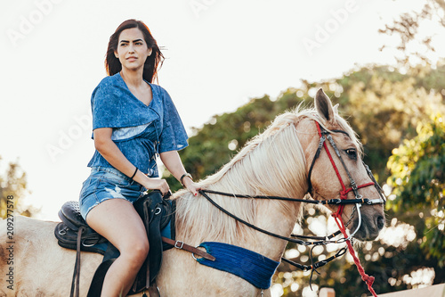 Young woman riding horse on the countryside © kleberpicui