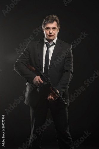 Handsome middle aged man gangster with Thompson machine gun