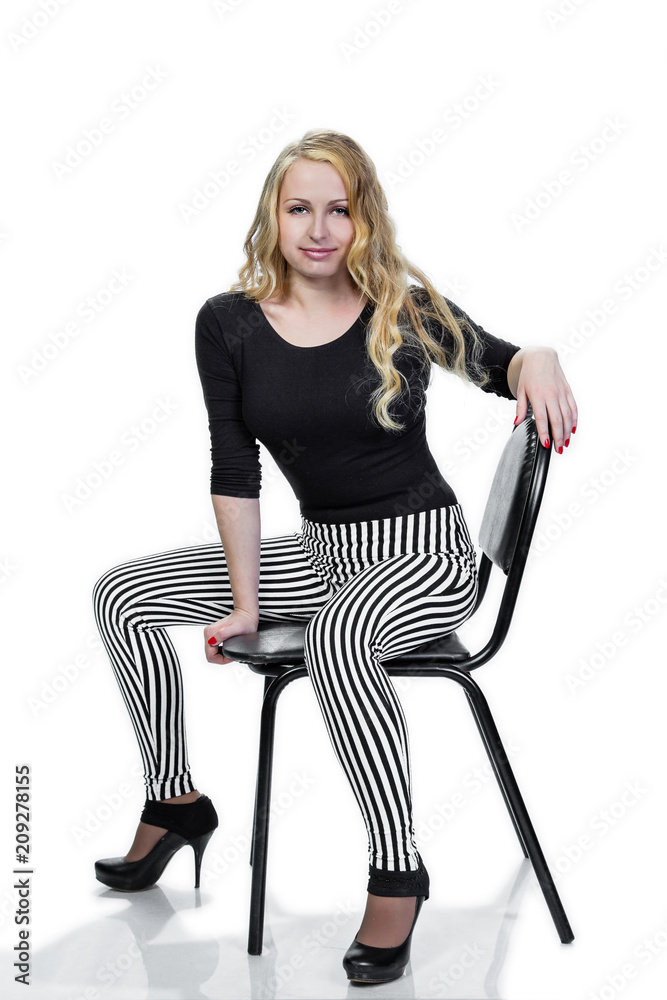 Fototapeta premium young blonde girl posing on chair.