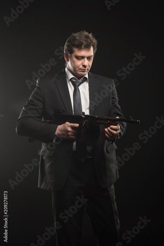 Handsome middle aged man gangster with Thompson machine gun