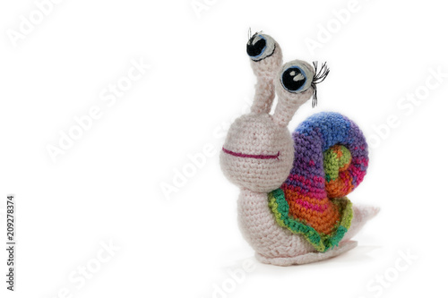 Crochet rainbow snail with eyes, on white background. Amigurumi. Handmade