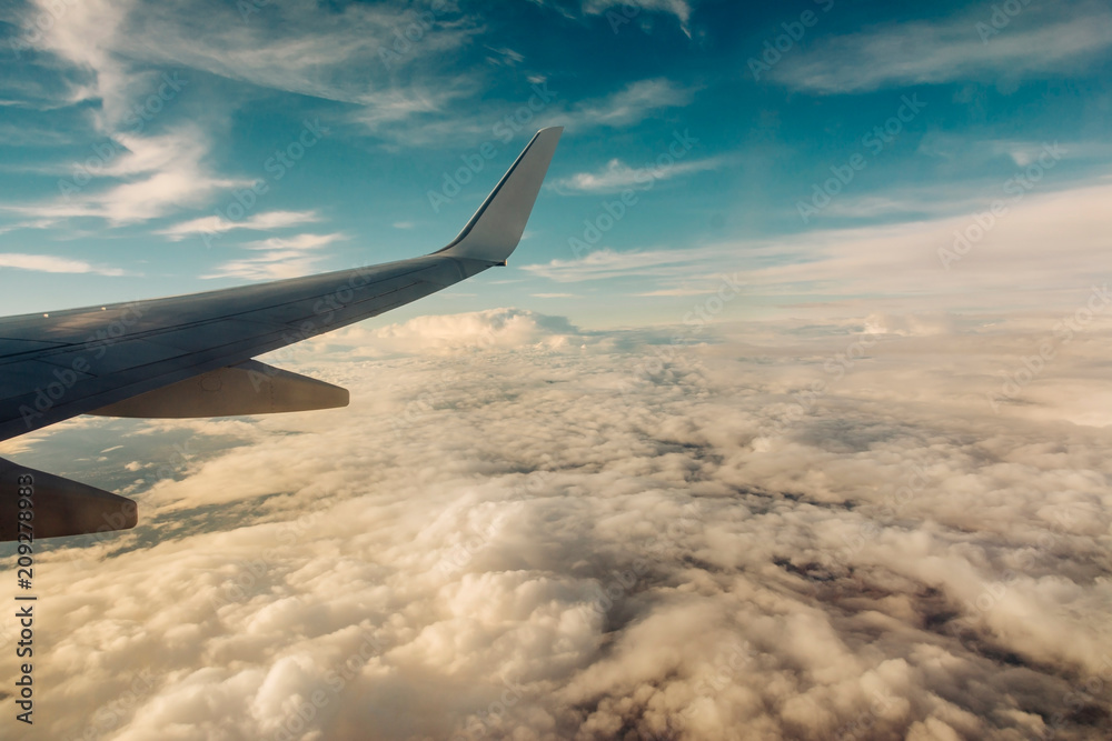 Clouds and sky as seen through window of an aircraft Clouds and sky as seen through window of an aircraft