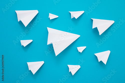 White paper planes on a blue background. Telegram symbol